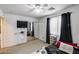 Bright bedroom with fan, carpet, mounted television, and window at 1517 E Elaine Dr, Casa Grande, AZ 85122