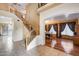 Inviting entryway with tile flooring, a staircase, and an archway leading to the dining area at 1517 E Elaine Dr, Casa Grande, AZ 85122