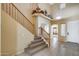Bright foyer boasts staircase, tile flooring, and decorative ledge, creating a warm, inviting space at 1517 E Elaine Dr, Casa Grande, AZ 85122