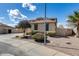 Charming home exterior with desert landscaping, showcasing curb appeal and a well-maintained lawn at 1517 E Elaine Dr, Casa Grande, AZ 85122
