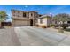 Two-story home with a large driveway, stone accents, and desert landscaping at 1517 E Elaine Dr, Casa Grande, AZ 85122