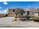 Beautiful two-story home with a tile roof, well-maintained landscaping, and a two car garage at 1517 E Elaine Dr, Casa Grande, AZ 85122