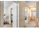 Upstairs hallway with carpeted floors and view into other rooms; an elliptical machine visible in one room at 1517 E Elaine Dr, Casa Grande, AZ 85122