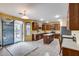 Open kitchen with stainless steel appliances, center island, and sliding door to backyard patio at 1517 E Elaine Dr, Casa Grande, AZ 85122