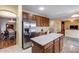 Bright eat-in kitchen with stainless steel refrigerator, island, and seamless flow to dining area at 1517 E Elaine Dr, Casa Grande, AZ 85122