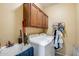 Functional laundry room with washer, dryer, utility sink, and storage cabinets for easy organization at 1517 E Elaine Dr, Casa Grande, AZ 85122