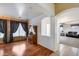 Bright living room featuring an archway, hutch, and window with dark curtains at 1517 E Elaine Dr, Casa Grande, AZ 85122