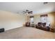 Spacious living room with a ceiling fan, two windows, and comfortable seating at 1517 E Elaine Dr, Casa Grande, AZ 85122