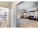View of a living room with carpet, ceiling fan, and a view of the bathroom at 1517 E Elaine Dr, Casa Grande, AZ 85122