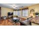 Cozy living room with laminate floors, a ceiling fan, and large windows offering lots of natural light at 1517 E Elaine Dr, Casa Grande, AZ 85122