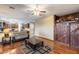Inviting open-concept living room with laminate floors, adjacent kitchen, and stylish barn door detail at 1517 E Elaine Dr, Casa Grande, AZ 85122