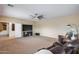 Living room offering a ceiling fan, lots of space, and comfortable leather seating at 1517 E Elaine Dr, Casa Grande, AZ 85122