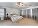 Carpeted primary bedroom featuring a ceiling fan, lots of natural light, and neutral paint at 1517 E Elaine Dr, Casa Grande, AZ 85122