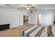 Spacious main bedroom featuring a ceiling fan, plush carpet, and access to the upper level of the home at 1517 E Elaine Dr, Casa Grande, AZ 85122