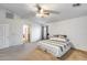 Spacious main bedroom with ceiling fan, neutral paint, and doorway to en suite bathroom at 1517 E Elaine Dr, Casa Grande, AZ 85122