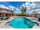 Backyard oasis with a large pool, covered patio, and lush landscaping at 1517 E Elaine Dr, Casa Grande, AZ 85122
