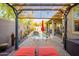 Serene backyard oasis with a pergola, patio seating, and a sparkling pool, perfect for relaxation at 15796 W Shaw Butte Dr, Surprise, AZ 85379