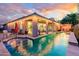Resort-style backyard features a refreshing pool, covered patio, and cozy seating areas, ideal for outdoor living at 15796 W Shaw Butte Dr, Surprise, AZ 85379