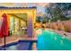 Picturesque backyard with a shimmering pool, elegant water features, and a covered patio, perfect for relaxation and entertaining at 15796 W Shaw Butte Dr, Surprise, AZ 85379