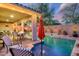 Charming backyard with a sparkling pool, covered patio, and well-maintained landscaping perfect for relaxing and entertaining at 15796 W Shaw Butte Dr, Surprise, AZ 85379