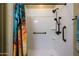 Bathroom shower featuring a modern shower head, built-in shelves, and stylish, colorful curtain at 15796 W Shaw Butte Dr, Surprise, AZ 85379
