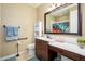 Bathroom features a large mirror, a vanity with sink and a shower behind a sliding glass door at 15796 W Shaw Butte Dr, Surprise, AZ 85379
