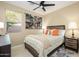 Cozy bedroom with a comfortable bed, decorative pillows, and plenty of natural light from the window at 15796 W Shaw Butte Dr, Surprise, AZ 85379