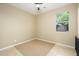 Bright bedroom featuring a beige carpet, window with tree view, and natural lighting at 15796 W Shaw Butte Dr, Surprise, AZ 85379