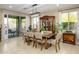 Bright dining room with a large table, china cabinet, and sliding door access to patio at 15796 W Shaw Butte Dr, Surprise, AZ 85379