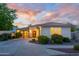 Stunning front exterior featuring a well-manicured lawn, mature trees, and a welcoming entrance, showcasing curb appeal at 15796 W Shaw Butte Dr, Surprise, AZ 85379