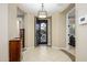 Elegant foyer with tile flooring, a decorative front door, and an open layout, creating a grand entrance at 15796 W Shaw Butte Dr, Surprise, AZ 85379