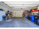 Spacious garage with ample storage, including shelving, cabinets, and room for multiple vehicles and projects at 15796 W Shaw Butte Dr, Surprise, AZ 85379