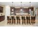 Spacious kitchen features granite countertops, dark wood cabinets, and bar stool seating at 15796 W Shaw Butte Dr, Surprise, AZ 85379