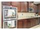 Gourmet kitchen boasts stainless steel double ovens and rich wood cabinetry at 15796 W Shaw Butte Dr, Surprise, AZ 85379
