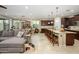 Open concept living space with kitchen island, dining area, and comfortable Gathering room at 15796 W Shaw Butte Dr, Surprise, AZ 85379
