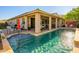 Beautiful backyard features a pristine pool, a covered patio with stylish furniture, and ample space for outdoor gatherings at 15796 W Shaw Butte Dr, Surprise, AZ 85379