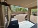 View of covered patio and gravel backyard with privacy wall, creating an outdoor oasis at 16010 N 170Th Ln, Surprise, AZ 85388