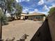 Wide-angle view of a large gravel backyard with a covered patio at 16010 N 170Th Ln, Surprise, AZ 85388