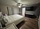 This large bedroom features a ceiling fan, wood look flooring, and a large window at 16010 N 170Th Ln, Surprise, AZ 85388