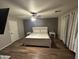 Cozy bedroom featuring a ceiling fan and a rustic wood-trimmed bed on wood look flooring at 16010 N 170Th Ln, Surprise, AZ 85388
