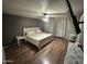 Inviting bedroom with a ceiling fan, wood look floors, and white curtains at 16010 N 170Th Ln, Surprise, AZ 85388