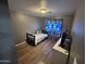 This bedroom features laminate wood floors and a window with decorative curtains at 16010 N 170Th Ln, Surprise, AZ 85388
