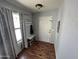Inviting entryway with wood floors, coat rack, bench, and natural light from the window at 16010 N 170Th Ln, Surprise, AZ 85388