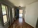 Welcoming foyer with wood-look flooring, coat rack, shoe bench, and view of open front door at 16010 N 170Th Ln, Surprise, AZ 85388