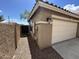 Side view of a home showing the garage, side yard access, and exterior details at 16010 N 170Th Ln, Surprise, AZ 85388