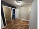 Hallway featuring hardwood floors and multiple doors at 16010 N 170Th Ln, Surprise, AZ 85388