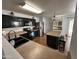 Functional kitchen featuring dark cabinetry, stainless steel appliances, and a convenient island at 16010 N 170Th Ln, Surprise, AZ 85388