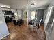 Open kitchen with black cabinets, a center island with seating, and stainless steel appliances at 16010 N 170Th Ln, Surprise, AZ 85388