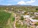 Stunning aerial view of the property showcasing the lush landscaping, golf course, and mountain views at 1607 N Quartz Valley Rd, Scottsdale, AZ 85266