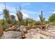 Relaxing back patio featuring desert landscaping, stone accents and comfortable seating at 1607 N Quartz Valley Rd, Scottsdale, AZ 85266